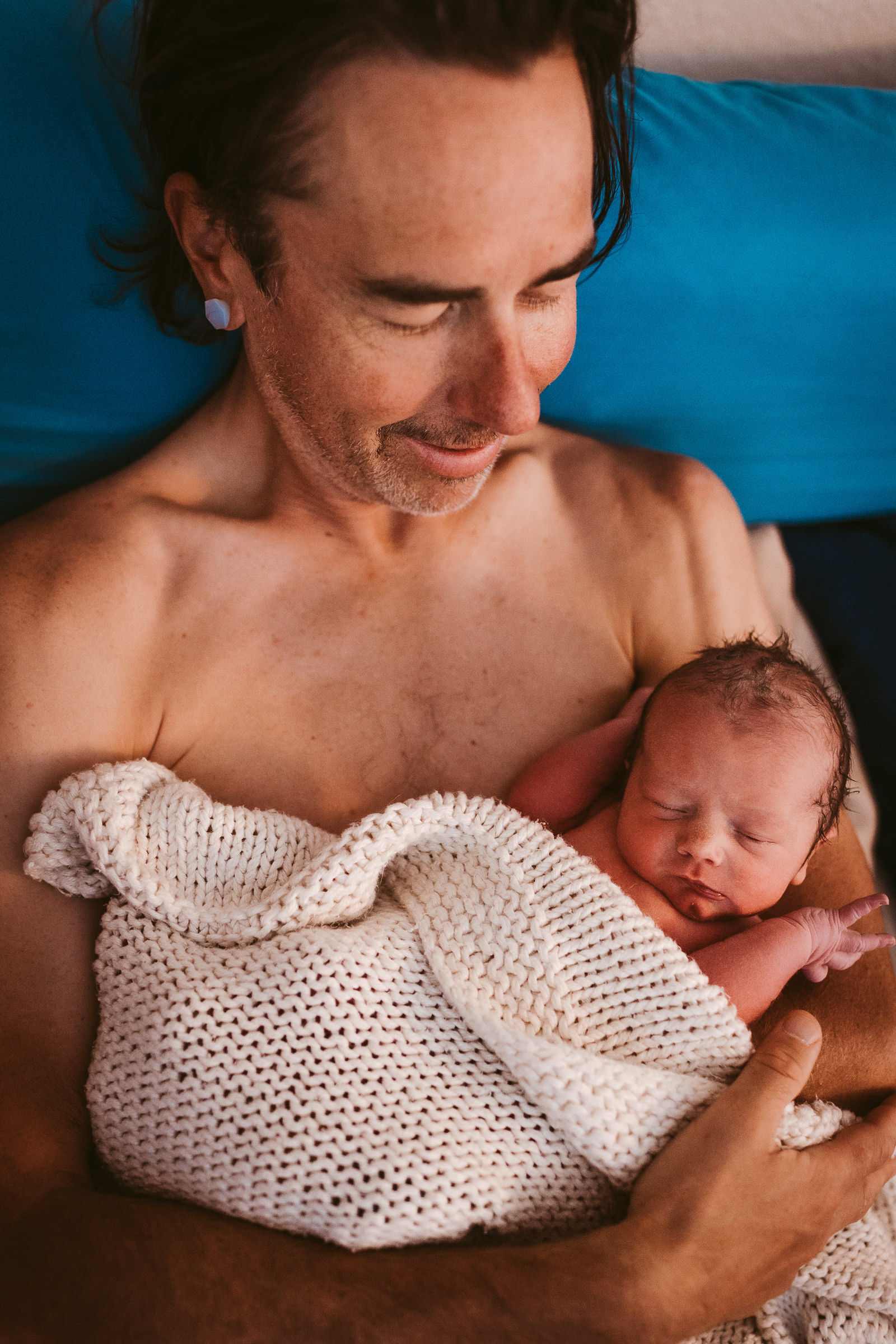 Dad holding newborn skin to skin
